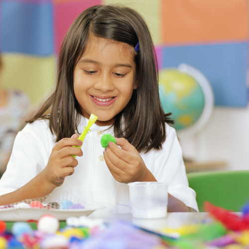 student doing a craft with her hands